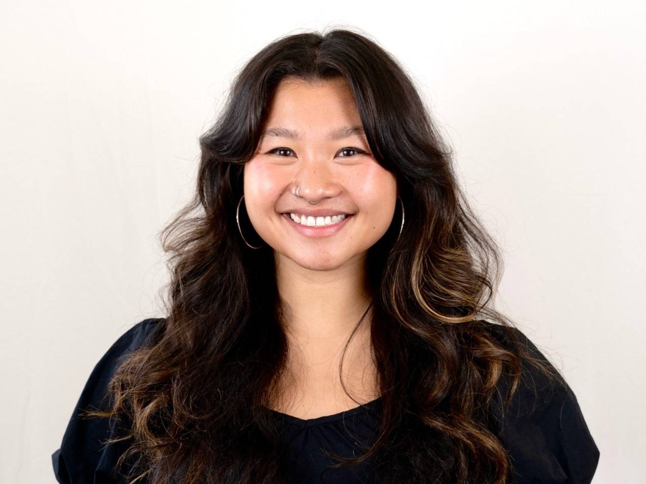 a woman with long hair smiling