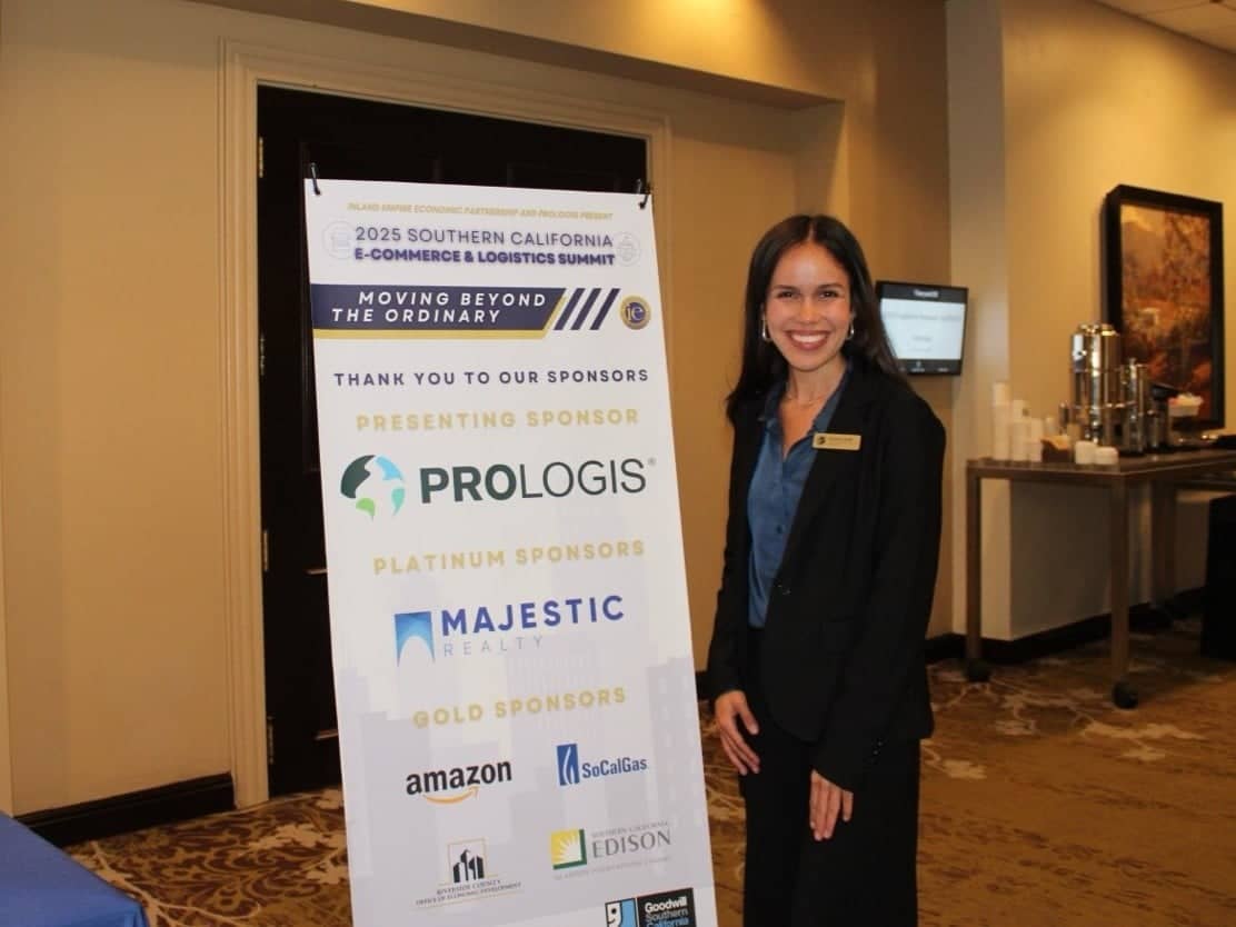 a woman standing next to a sign