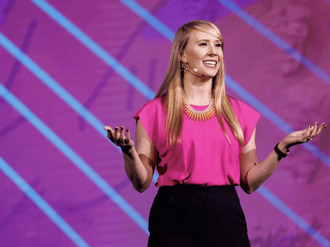 a woman in pink shirt and black pants