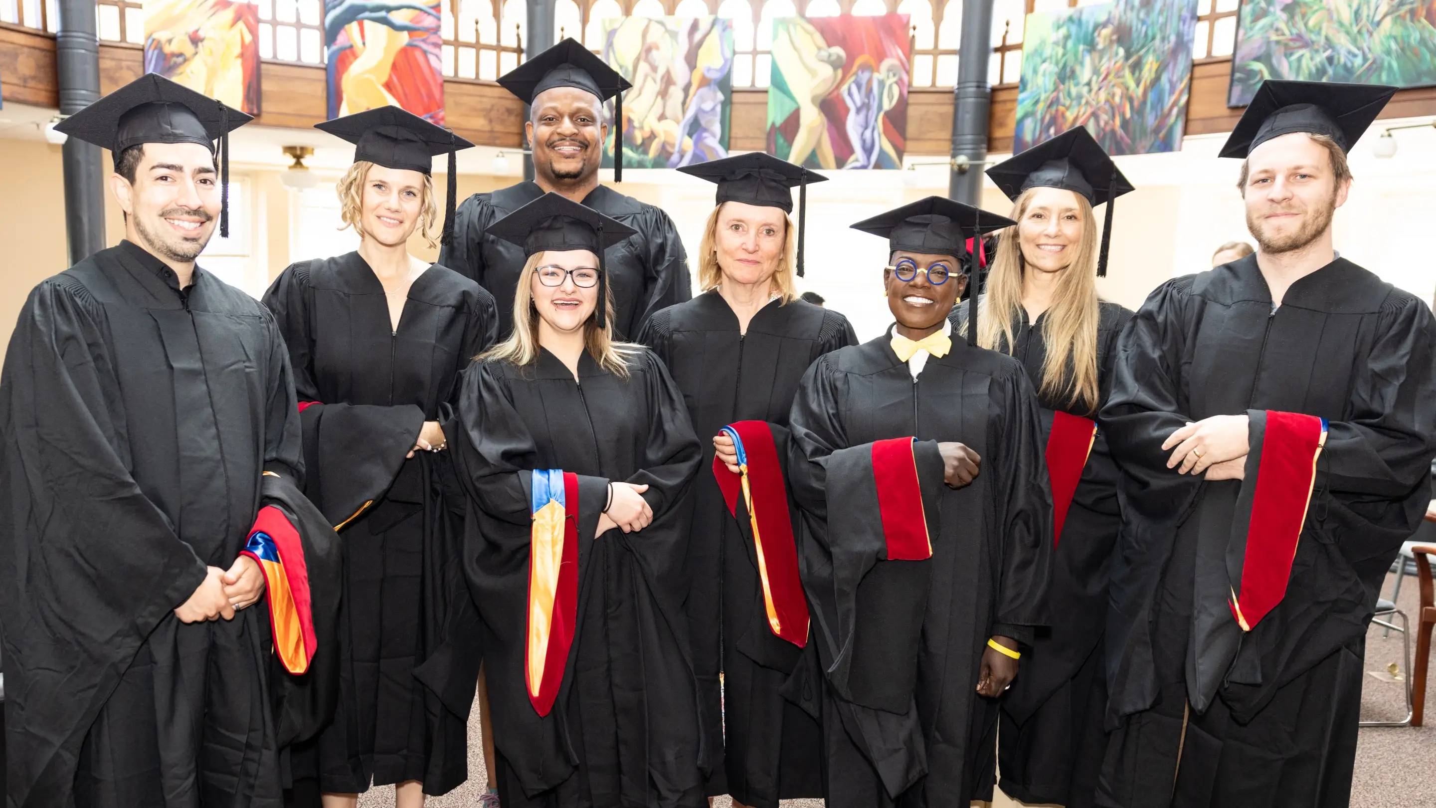 a group of people in graduation gowns and caps