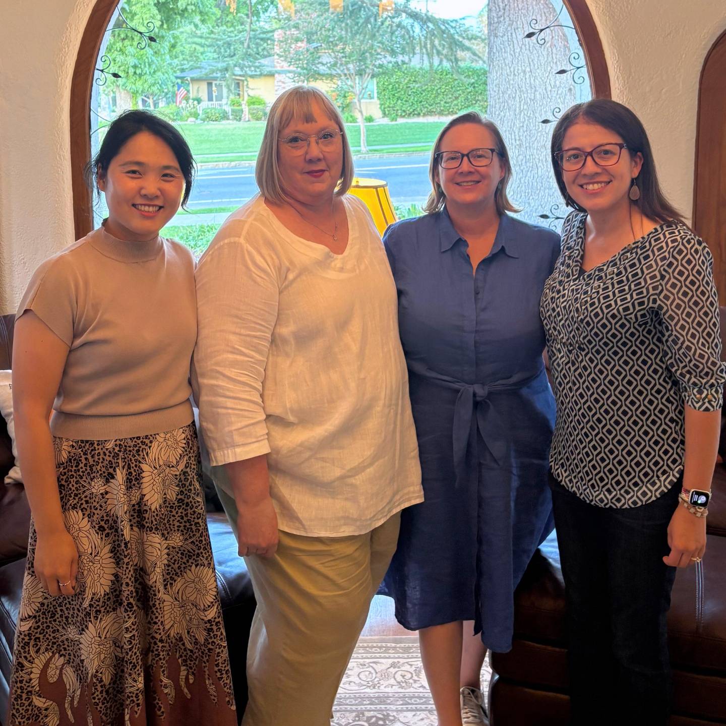 a group of women standing together smiling