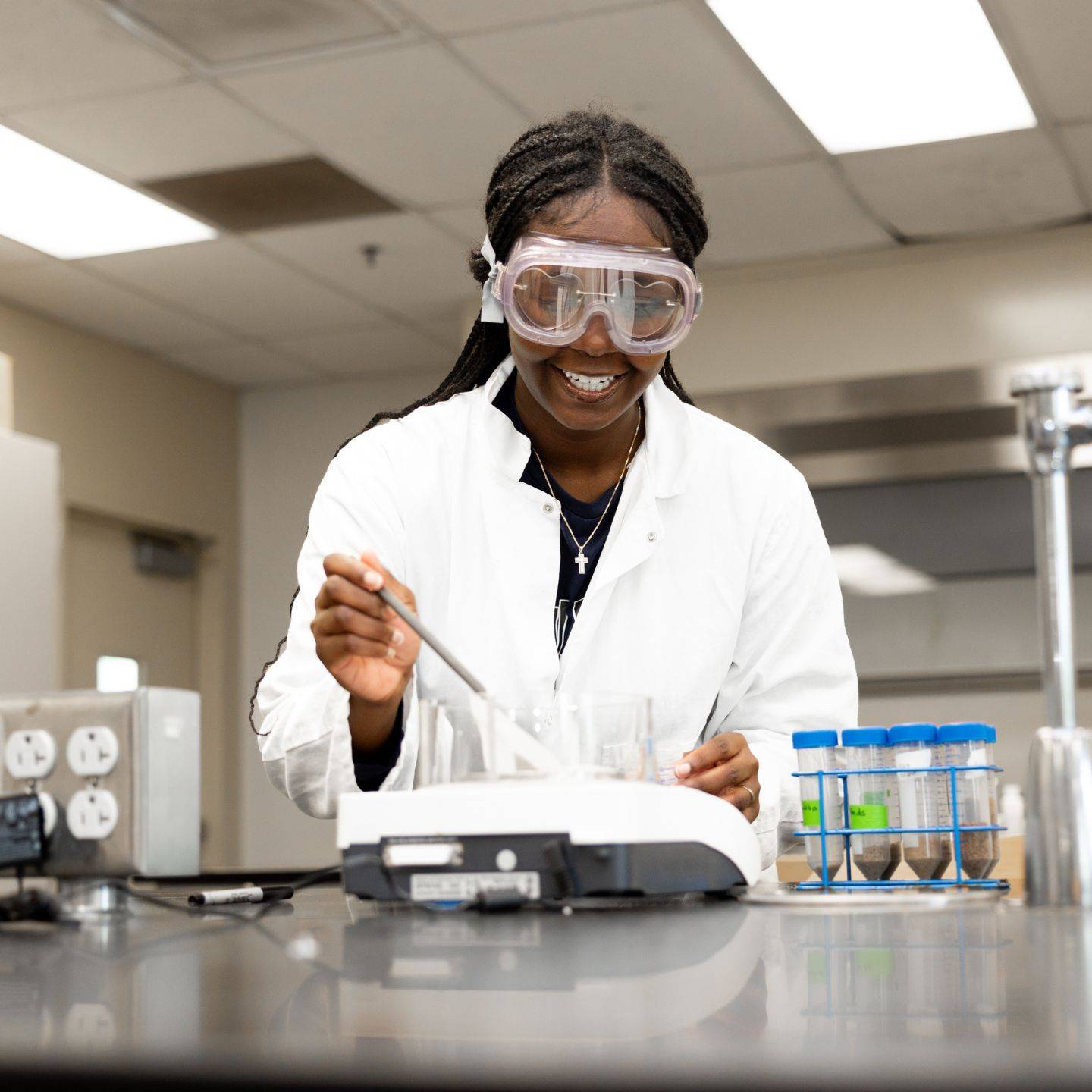 a woman wearing goggles and white coat