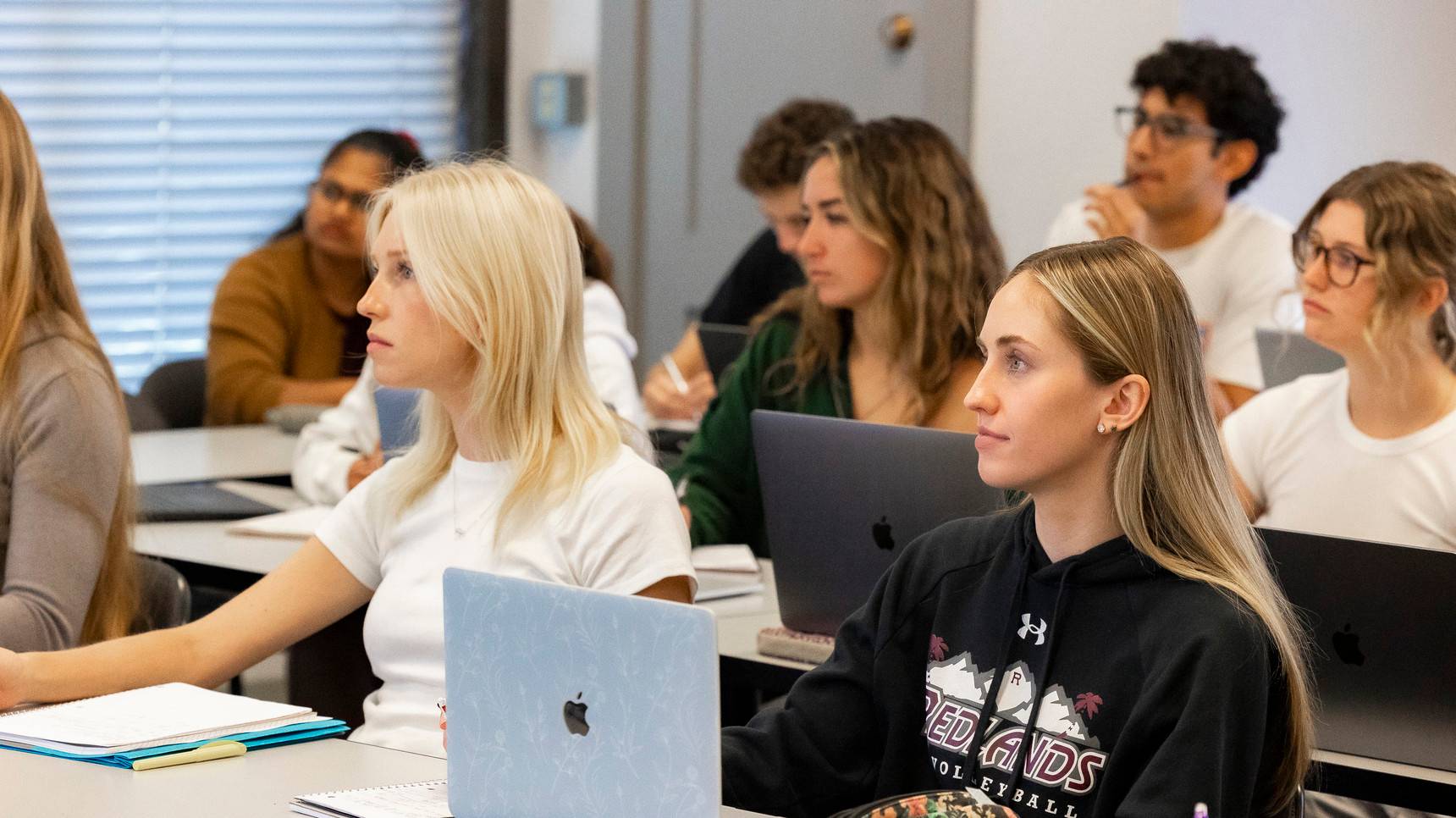 a group of women sitting in a classroom