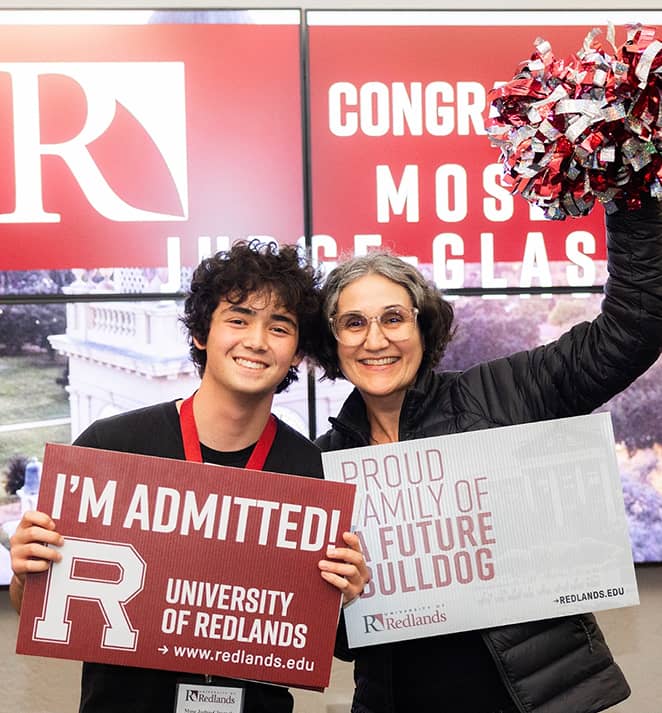 a man and woman holding signs