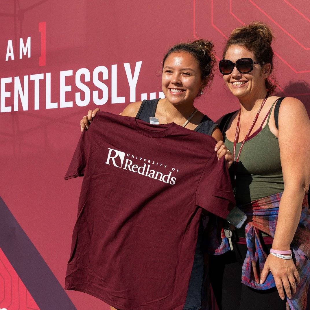 two women holding a shirt