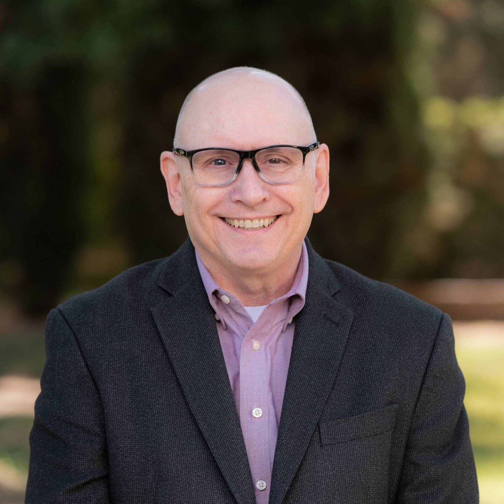 a man wearing glasses and a suit
