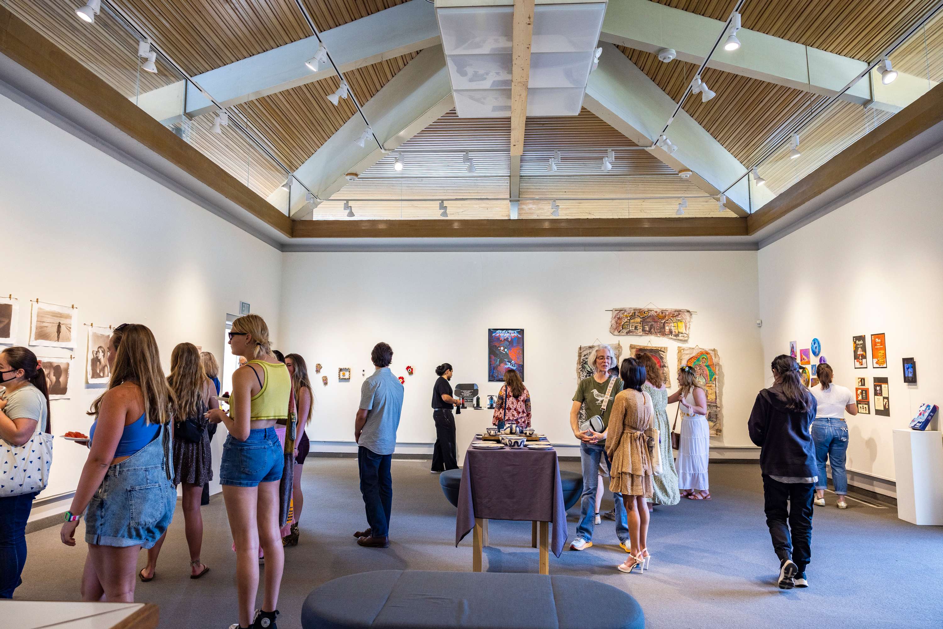 a group of people in a room with art on the wall