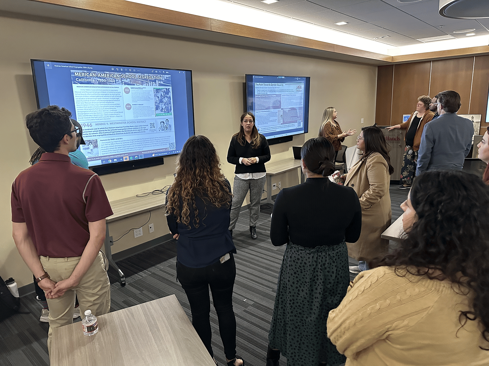 a group of people standing in front of a screen