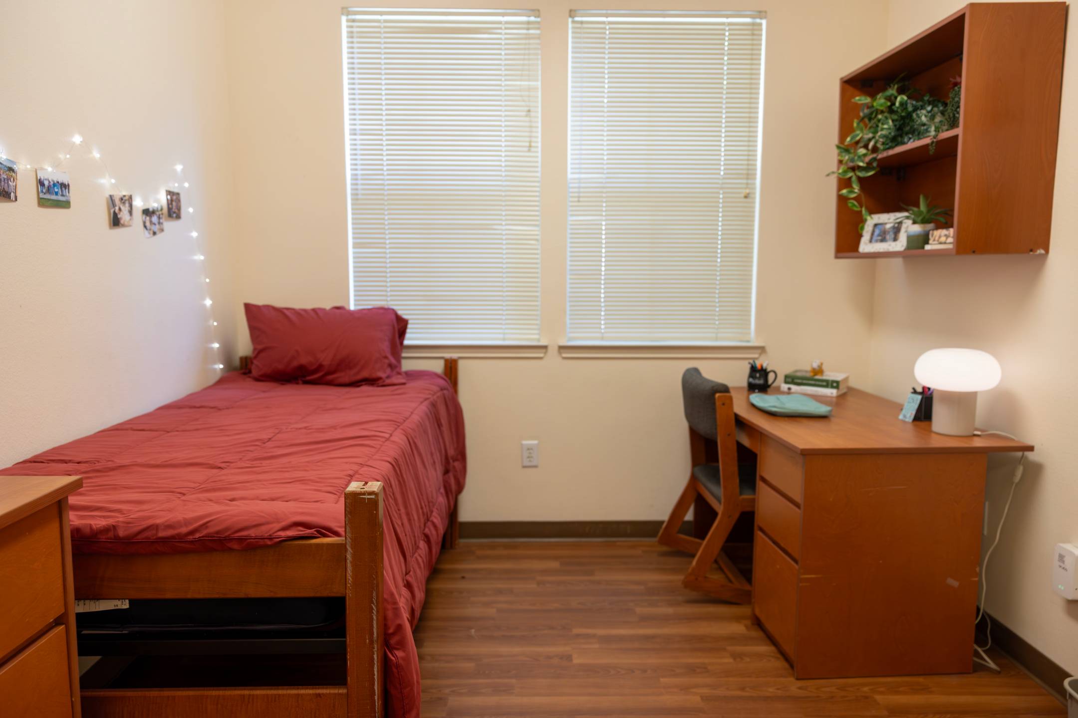 a bedroom with a desk and a bed