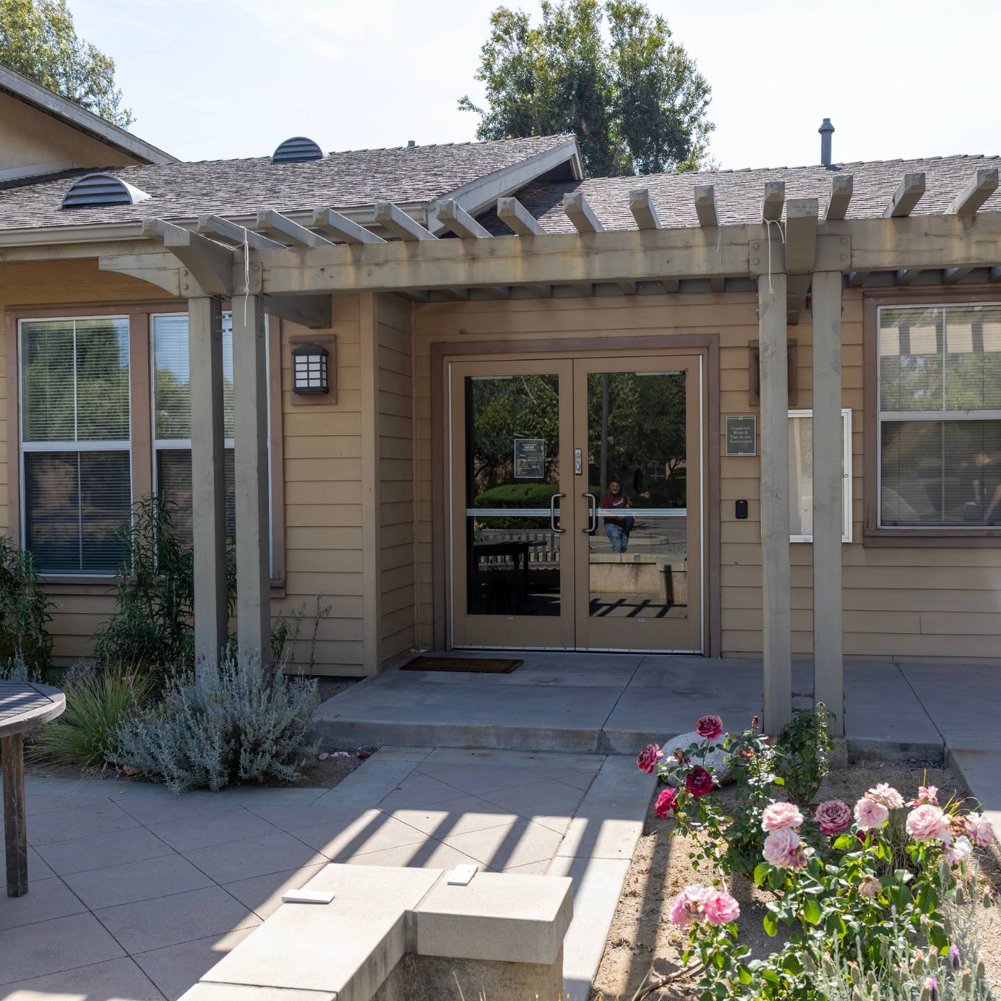 a house with a pergola and flowers