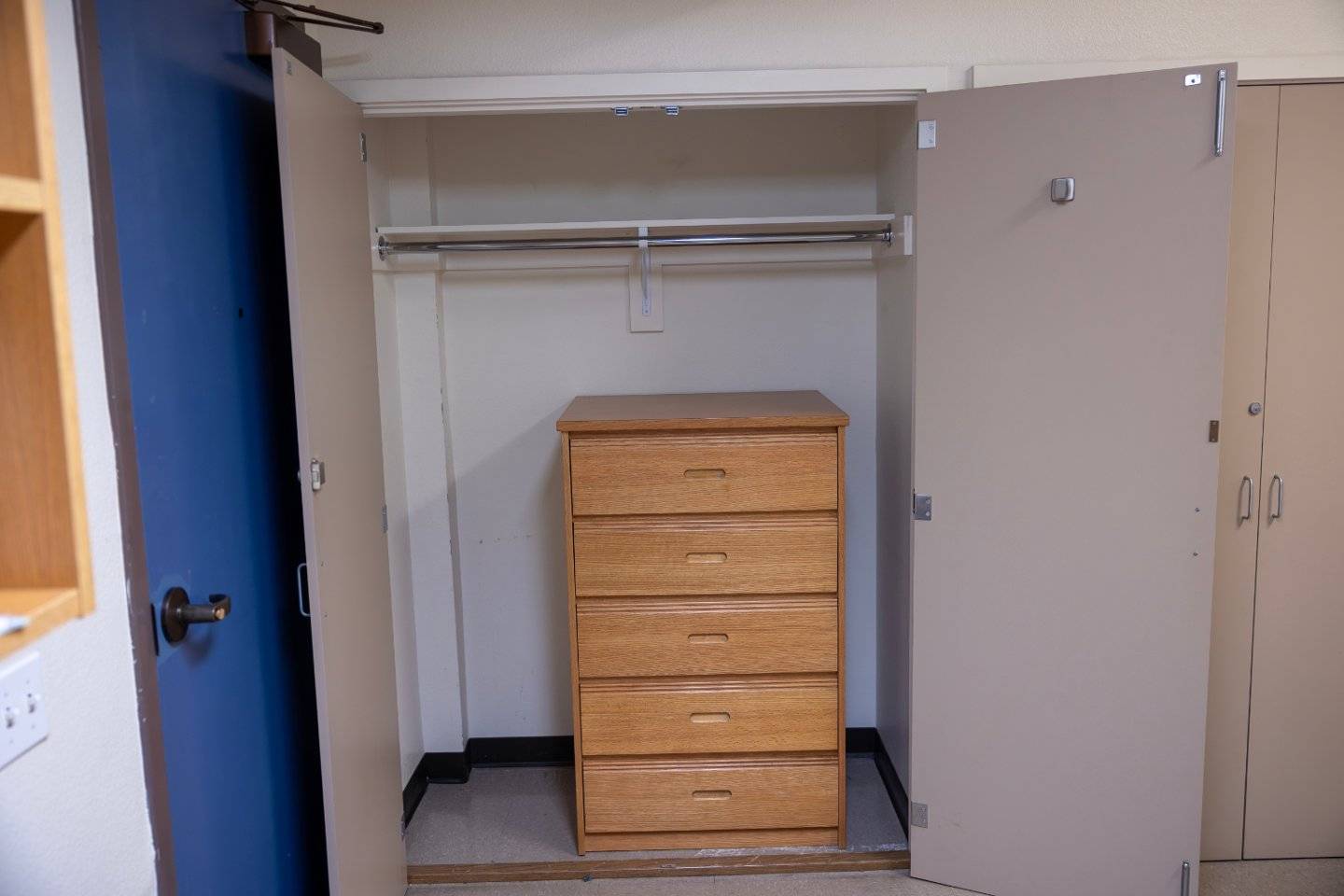 a closet with a drawer and a swinger