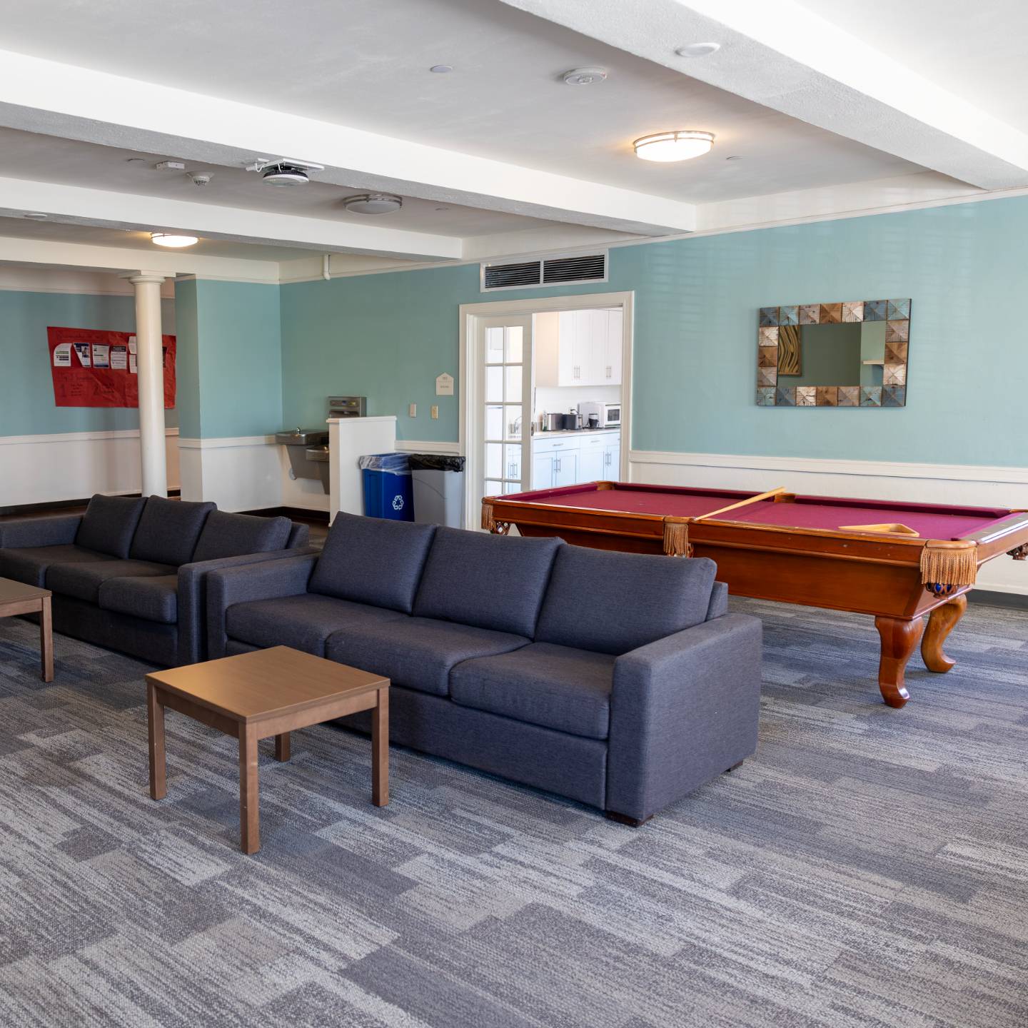 a pool table and couches in a room