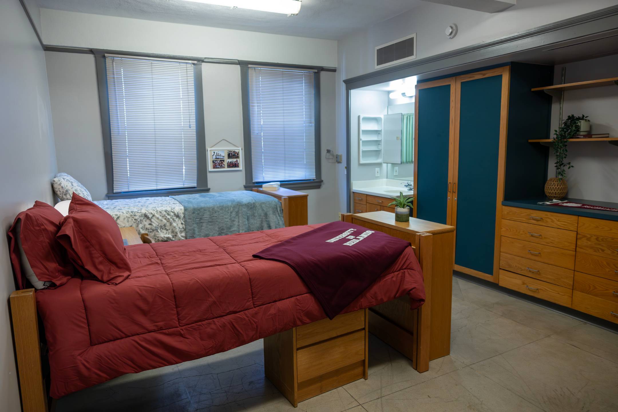 a room with two beds and a mirror