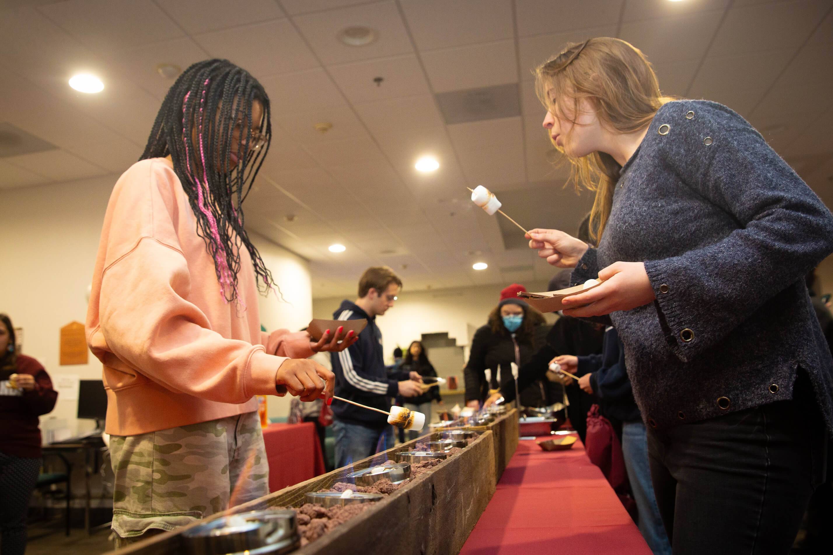 a group of people eating marshmallows