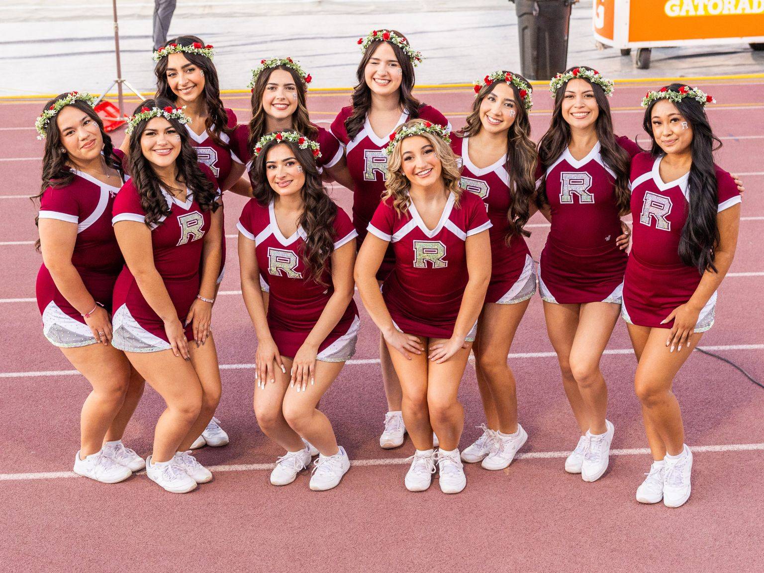 a group of cheerleaders posing for a photo