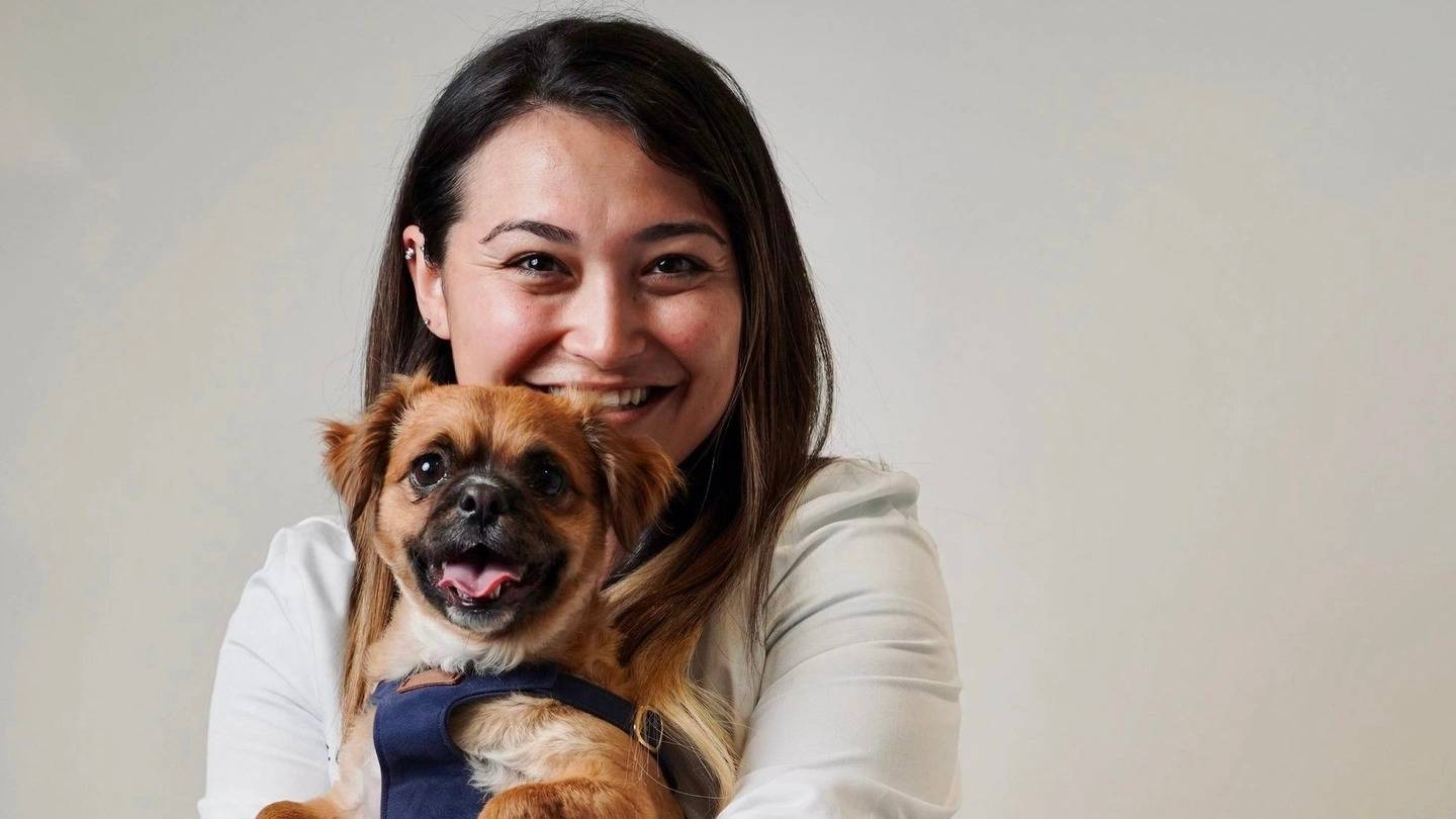 a woman holding a dog