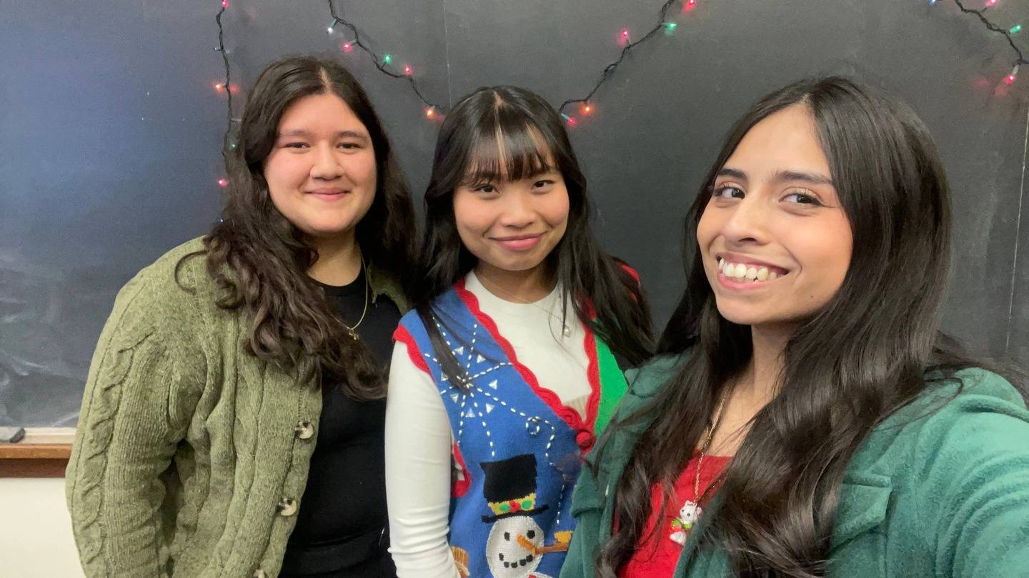a group of women smiling for a photo