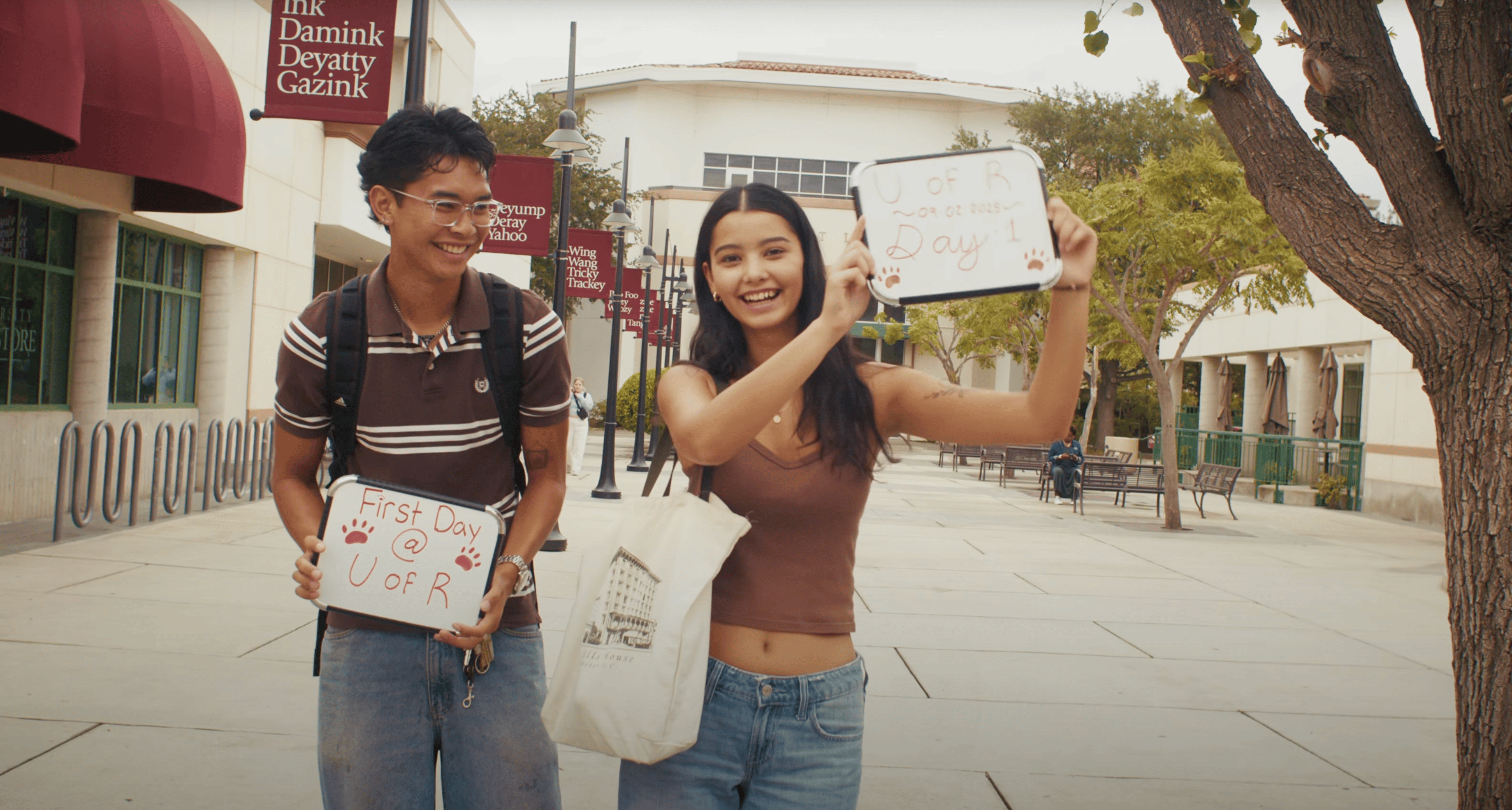 a man and woman holding signs