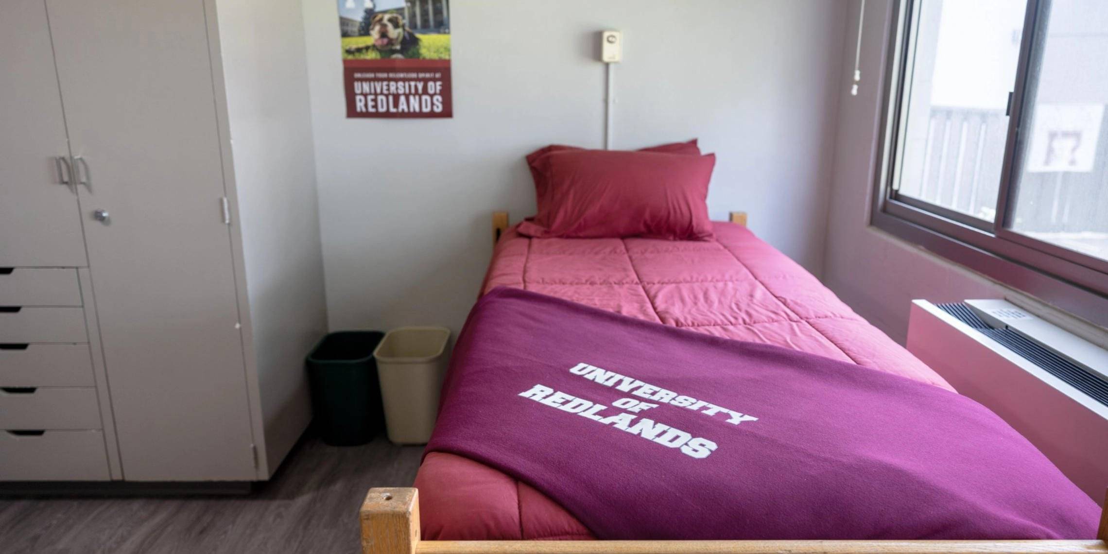 a bed with a blanket and pillows in a room