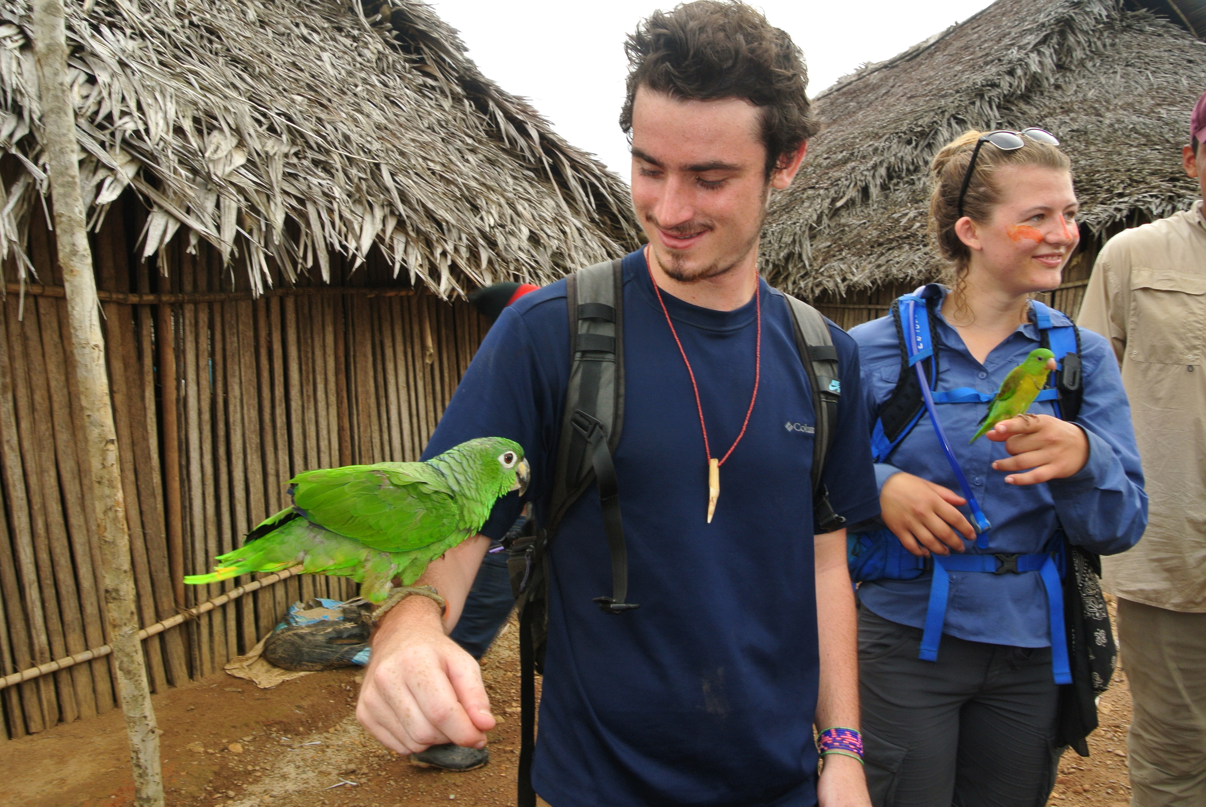 a man with a parrot on his arm