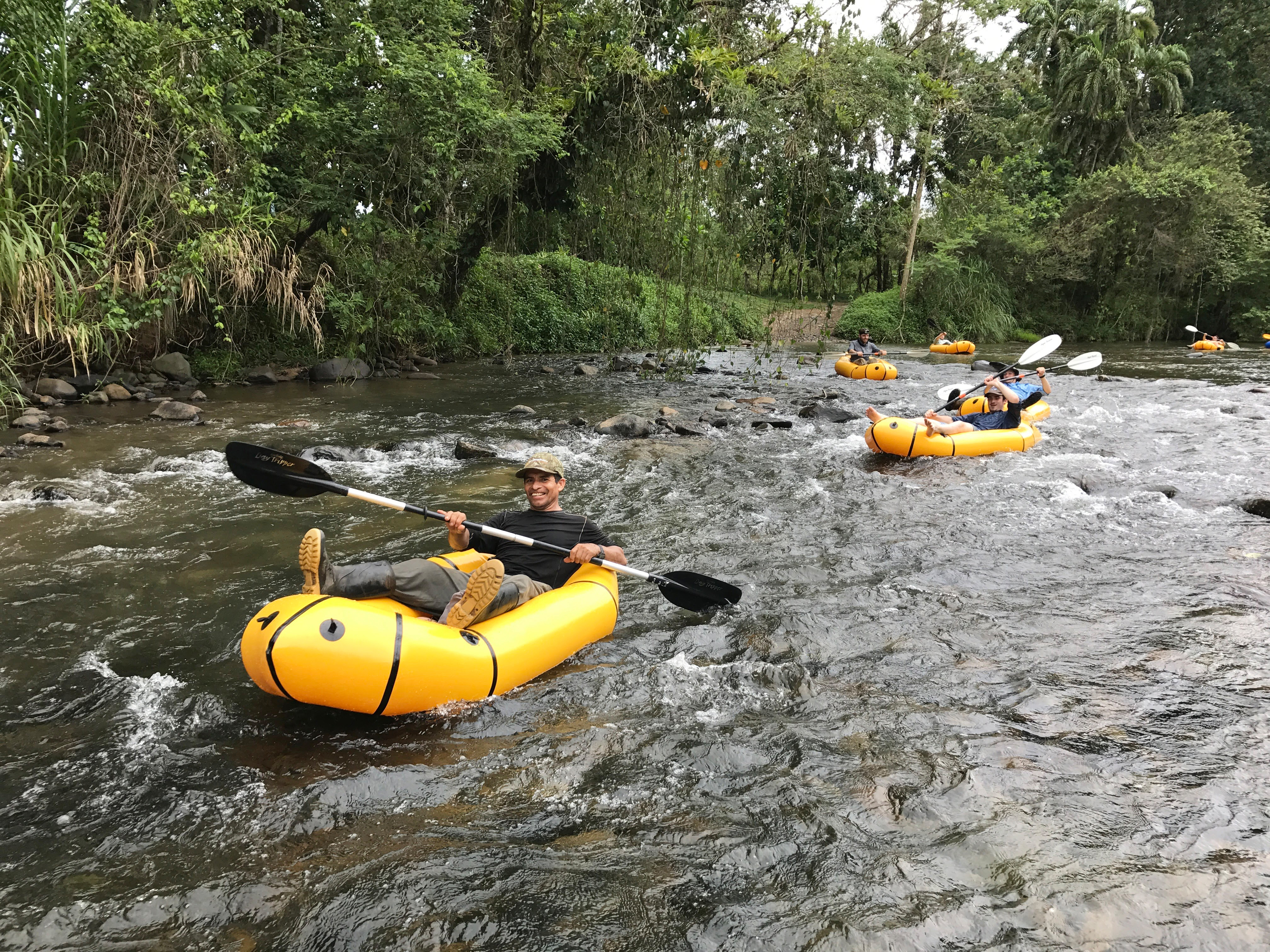 a group of people in rafts on a river