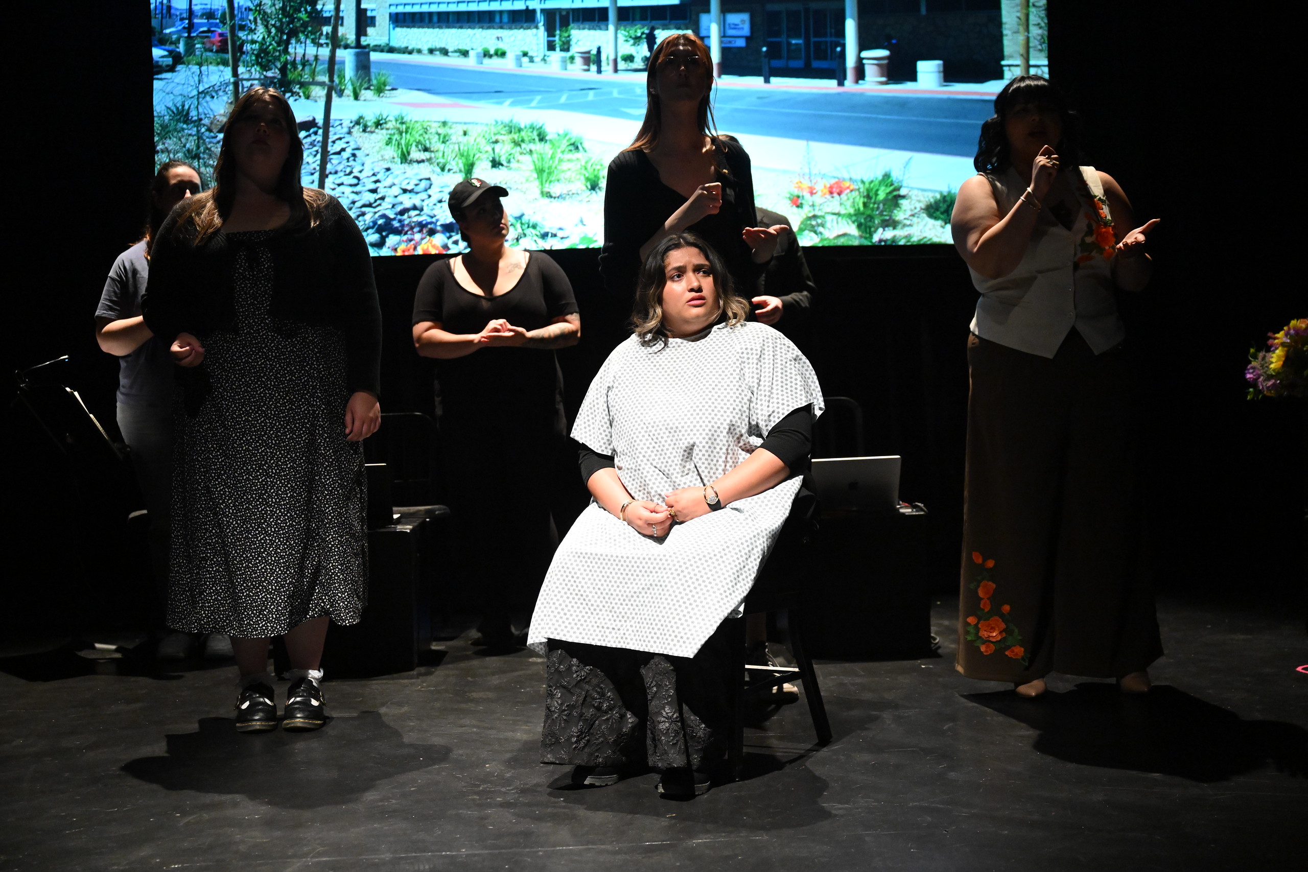 a group of women standing on a stage