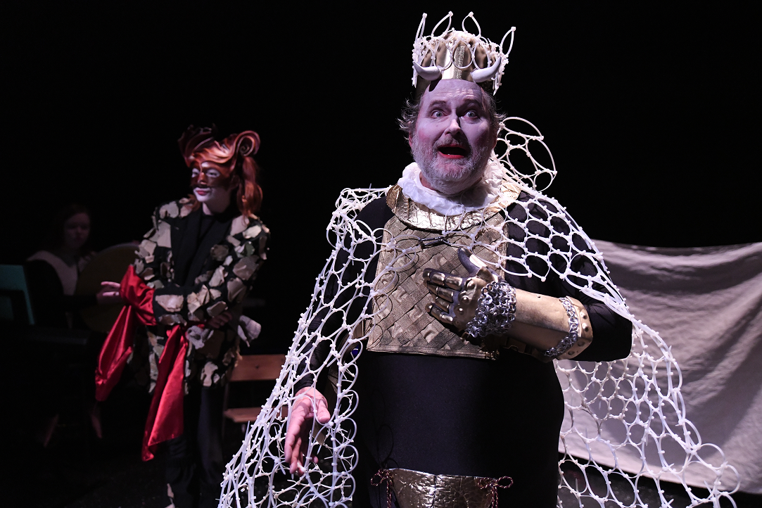 a man in garment with a white net around his neck