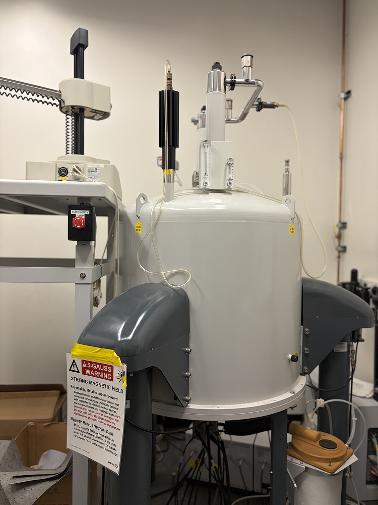 a white machine with black handles and a white sign