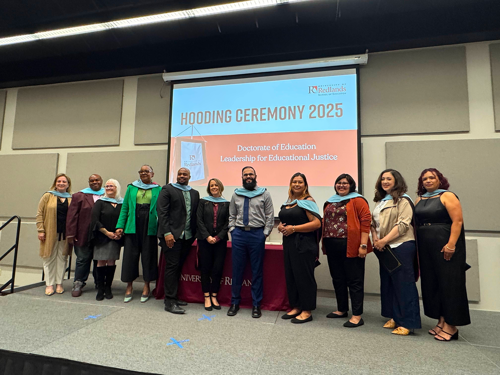 a group of people standing in front of a banner